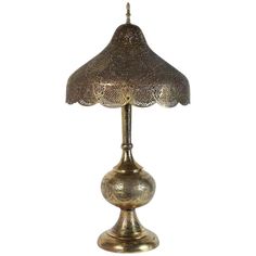 an antique brass table lamp on a white background