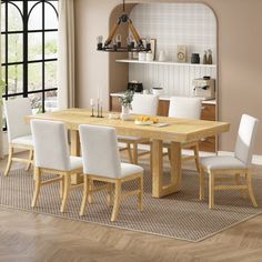 a dining room table with white chairs around it