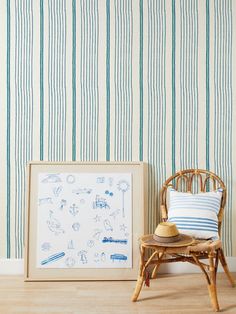 a chair next to a wall with blue and white stripes on it