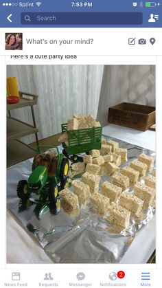 there is a cake made to look like a tractor and some blocks of rice on the table