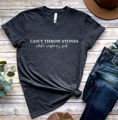 "\"Be the change you want to see in the world with our 'Can't Throw Stones While Washing Feet' shirt. A reminder that we should all be kind to one another, even when we disagree.\" 🕕Production Time 1-3 business day🕕 ➡️𝗛𝗢𝗪 𝗧𝗢 𝗢𝗥𝗗𝗘𝗥 ⬅️ 𝟏. Please, Check and Review all Photos. 𝟐. Select Your T-Shirt Size and T-Shirt Color from drop down menus. 𝟑. Enter your Design Color. 𝟒. Choose Your Quantity as much as you want. 𝟒. Click 𝗔𝗗𝗗 𝗧𝗢 𝗖𝗔𝗥𝗧. For multiple items go back to the lis Funny Cotton Tops With Quote Print, Inspirational Short Sleeve Tops With Funny Text, Inspirational Cotton Tops With Text Print, Inspirational Cotton Tops With Slogan, Inspirational Cotton Tops With Quote Print, Inspirational Cotton Slogan Tops, Inspirational Quote Print Cotton Top, Inspirational Slogan Short Sleeve Shirt, Crew Neck Cotton Shirt With Quote Print