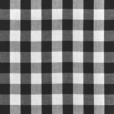 a black and white checkered fabric with a ruler in front of the plaid pattern