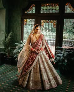 a woman in a bridal gown posing for the camera