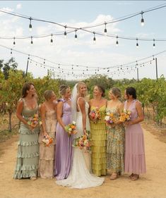 a group of women standing next to each other in front of a bunch of lights