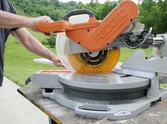 a man using a circular saw to cut wood