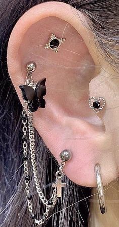 a woman wearing ear piercings with chains attached to her ears