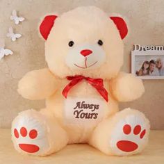 a white teddy bear with red paws and an always yours message on it's chest