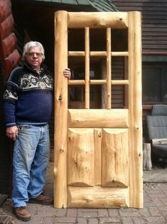 a man standing next to a wooden door