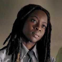 a woman with dreadlocks wearing a shirt and tie