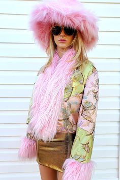 The Dancing Dragonfly Crop Jacket Dazzles with Dancing opalescent sequin dragonflies on the front and sleeves...AND THEN... gold damask pattern sequins covering the entire back of the jacket! A stunning patchwork design in pink and mint butterflies is underneath. Edged in luxurious long pile faux fur on the front opening, with wide fur cuffs.  Fully lined in pink satin, with a pocket on the side seam. Available in sizes XS-S-M-L-XL Matching Oversize Faux Fur Hat is sold seperately. Glamorous Pink Winter Outerwear, Pink Long Sleeve Outerwear For Party, Glamorous Pink Long Sleeve Outerwear, Glamorous Pink Sequined Outerwear, Pink Sequined Outerwear For Spring, Pink Outerwear For Party, Pink Fitted Party Outerwear, Pink Fitted Outerwear For Party, Pink Sequined Outerwear For Winter