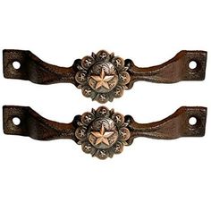 two brown wooden handles with metal decorations on them, one has a star and the other is