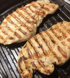 two pieces of meat cooking on top of a grill