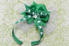 a green bow with white flowers on it