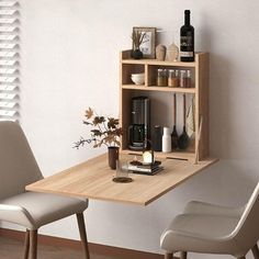 a small table with two chairs next to it and bottles on the shelf above it