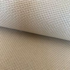 a close up view of a white fabric with small dots on it, as seen from above