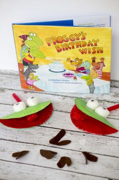 the froggy birthday wish book is next to two slices of watermelon with marshmallows on them