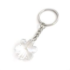 a white flower shaped key chain on a white background