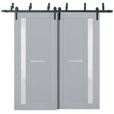 two gray doors with metal bars on each side