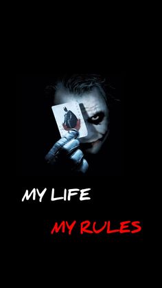 the joker holding up a card that says, my life is my rules