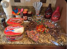 the ingredients for a candy bar are displayed on the counter top, including milk, cereals, and candies