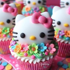 hello kitty cupcakes with flowers and bows on them are ready to be eaten