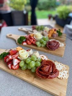 two wooden cutting boards topped with different types of food