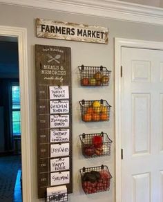 a wall hanging with baskets filled with fruits and vegetables next to a door that says farmers market