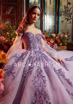 Look like a fairy-tale Princess in this glitter puff sleeve ball gown with A-line skirt by Ragazza Fashion EV17-617. This beautiful long off the shoulder dress features a deep illusion sweetheart bodice adorned with sequin appliques, detachable sheer puff sleeves, open lace-up corset back, and a floor length A-line skirt with a sweep train. Off Shoulder Puff Sleeve Quinceanera Dress by Ragazza EV17-617 Designer: Blossom Collection by Ragazza Fashion 2023 Style Number: EV17-617 Colors: Lilac Size Puff Sleeve Ball Gown, Lilac Quinceanera Dresses, Quinceanera Dresses Gold, Elegant Ball Gowns, Dress Ball Gown, Quince Dress, Dresses Ball Gown, Applique Wedding, Sequin Appliques