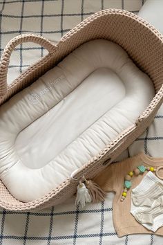 a baby's crib is laying on the bed next to some toys and other items