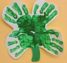 a pinterest page with an image of a handprinted shamrock on it