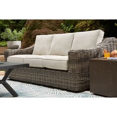 a wicker couch sitting on top of a patio