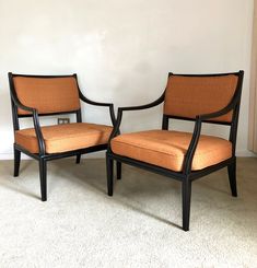 two chairs sitting next to each other in a room