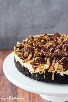 there is a cake with chocolate and caramel toppings on the top, then topped with ice cream