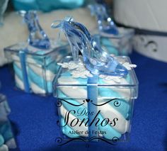 blue and white wedding favors with high heel shoes on display in clear boxes for the bride's guests