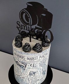 a cake decorated with newspaper paper and black icing