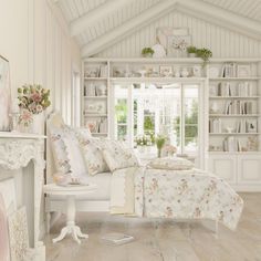 a bedroom with white furniture and flowers on the bedspread is shown in this image