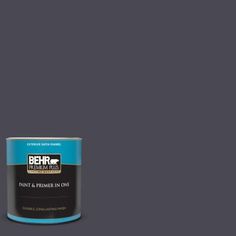 a can of behr paint and primer in one on a dark gray background