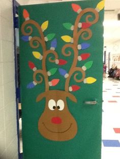 the door is decorated with christmas lights and a reindeer's head on it,