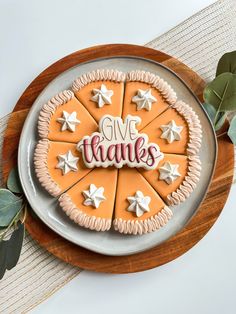 a plate that has cookies on it with the words give thanks written in white letters