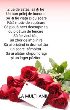 red roses and a card with the words la multi ani