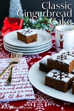 some brownies are sitting on plates near a cup and saucer, with the words classic gingerbread cake in front of them