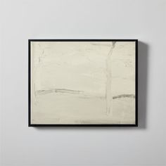 an abstract painting hanging on the wall in a black frame with white paint over it