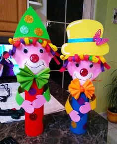 two paper mache clowns sitting on top of a counter