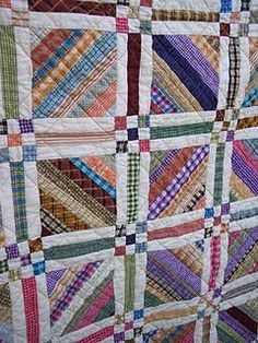 a multicolored quilt is hanging on the wall