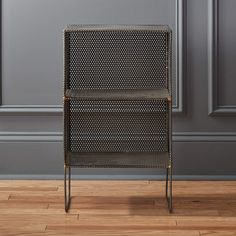 a chair sitting on top of a hard wood floor next to a gray painted wall