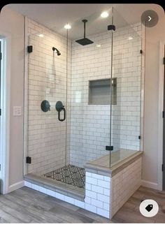 a walk in shower sitting inside of a bathroom next to a door and window on the wall