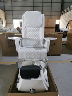 a white leather reclining chair in a warehouse