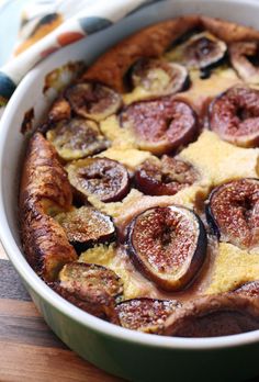 a close up of a pie with figs in it on a wooden table top