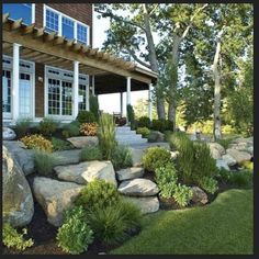 a large rock garden in front of a house