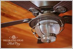 an old fashioned ceiling fan with glass shades